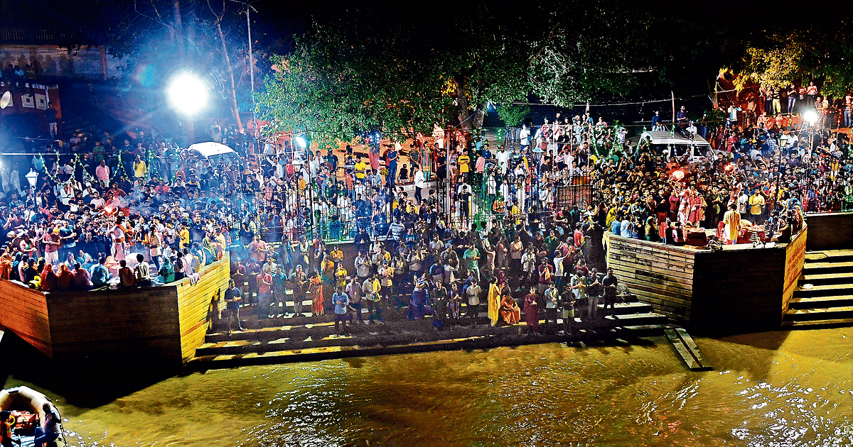 Supernatural scene on Ghat during Ganga Aarti, queues of spectators on JP Ganga Path